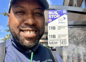 a man with a hat at a bus stop