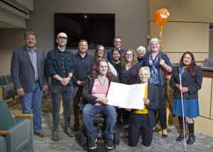 A group of people hold a proclamation for week without driving.